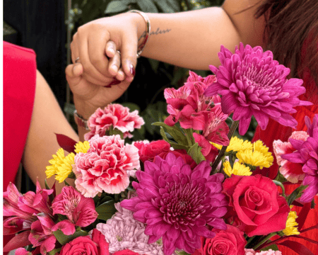 Close-up of pink and red flower arrangement with chrysanthemums and roses