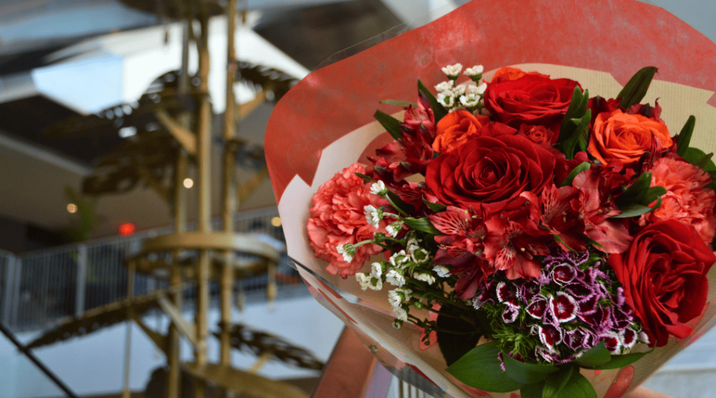Red and pink bouquet with gold chandelier background